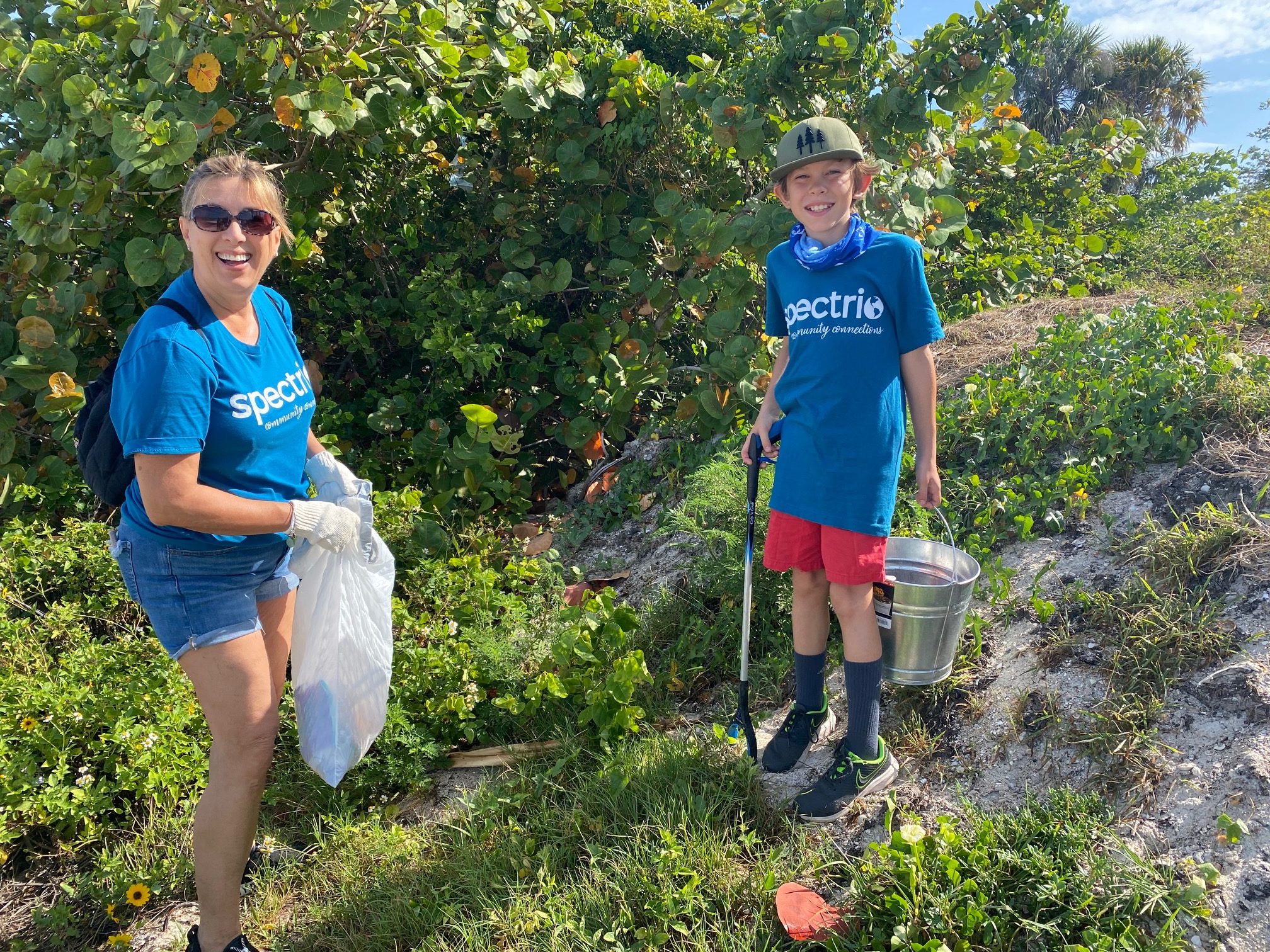 lady and boy cleaning up garbage