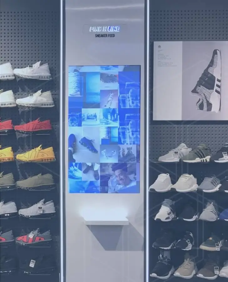 Finish Line Sneaker Feed digital signage in a retail store