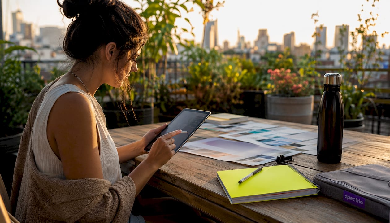 Marketing specialist adjusting digital signage content on tablet